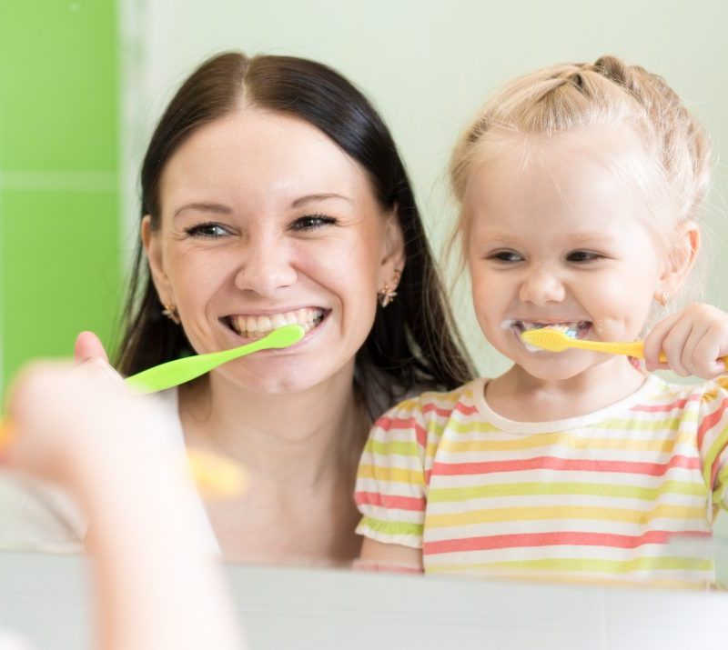 Mother and daughter brushing